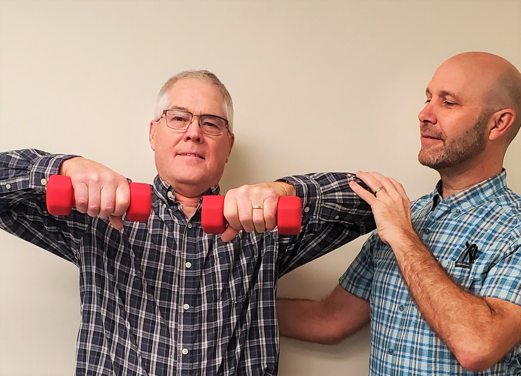 Physical therapist assisting with shoulder exercises