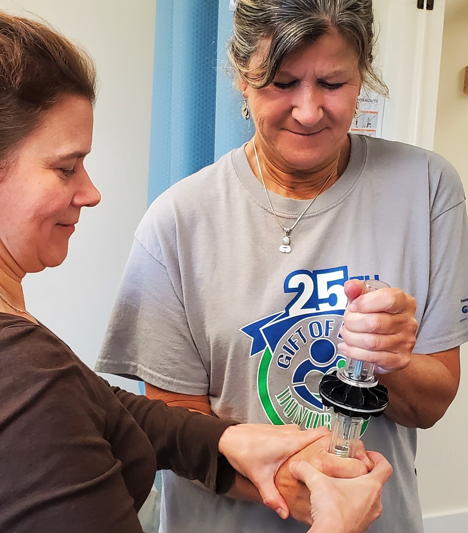 Physical therapist assisting with grip exercises